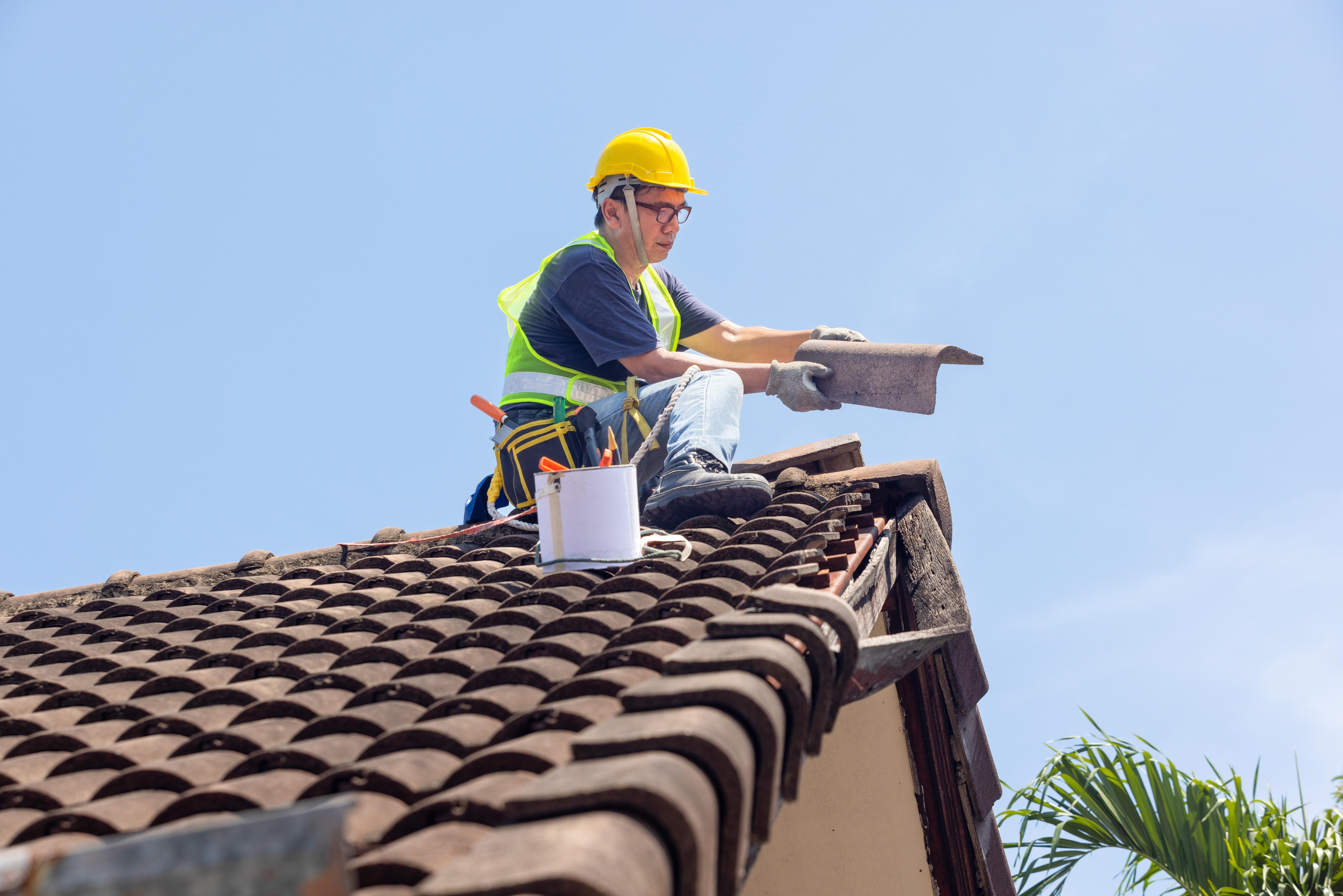 Roofing contractor inspecting and documenting a roof before replacement
